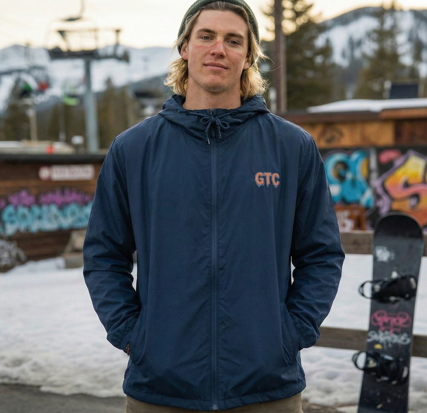 Person wearing a navy jacket with 'GTC' logo in an outdoor setting