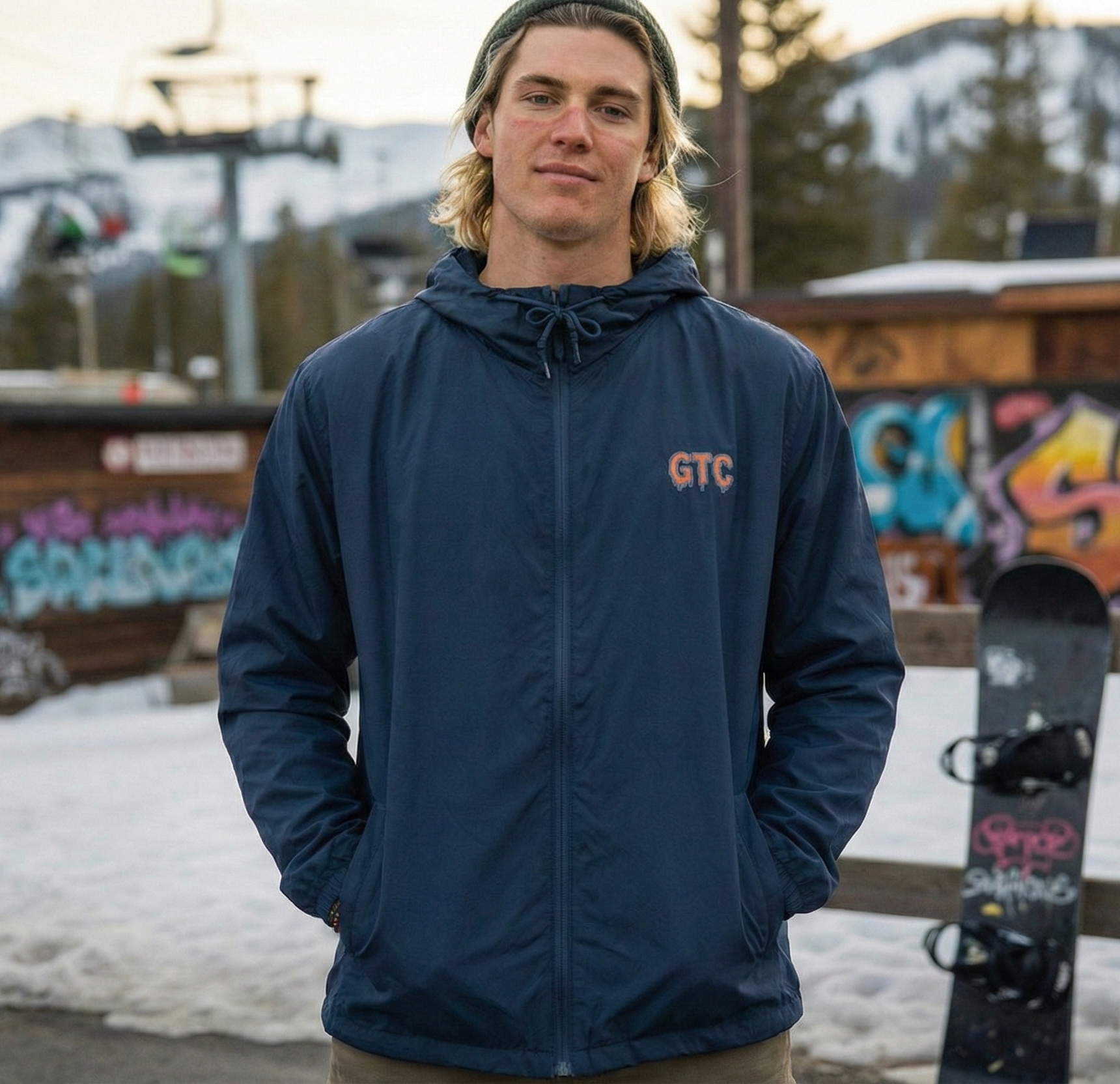 Person wearing a navy jacket with 'GTC' logo in an outdoor setting